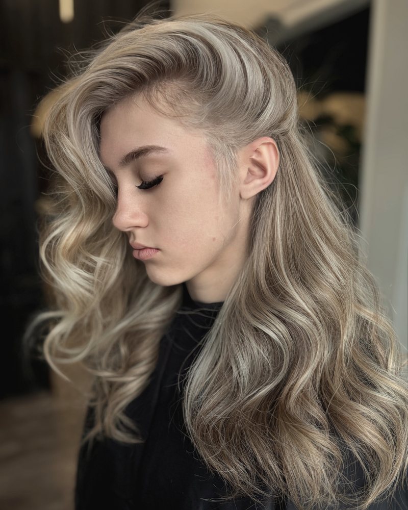 Soft blonde waves after a color service at Identity Salon & Spa