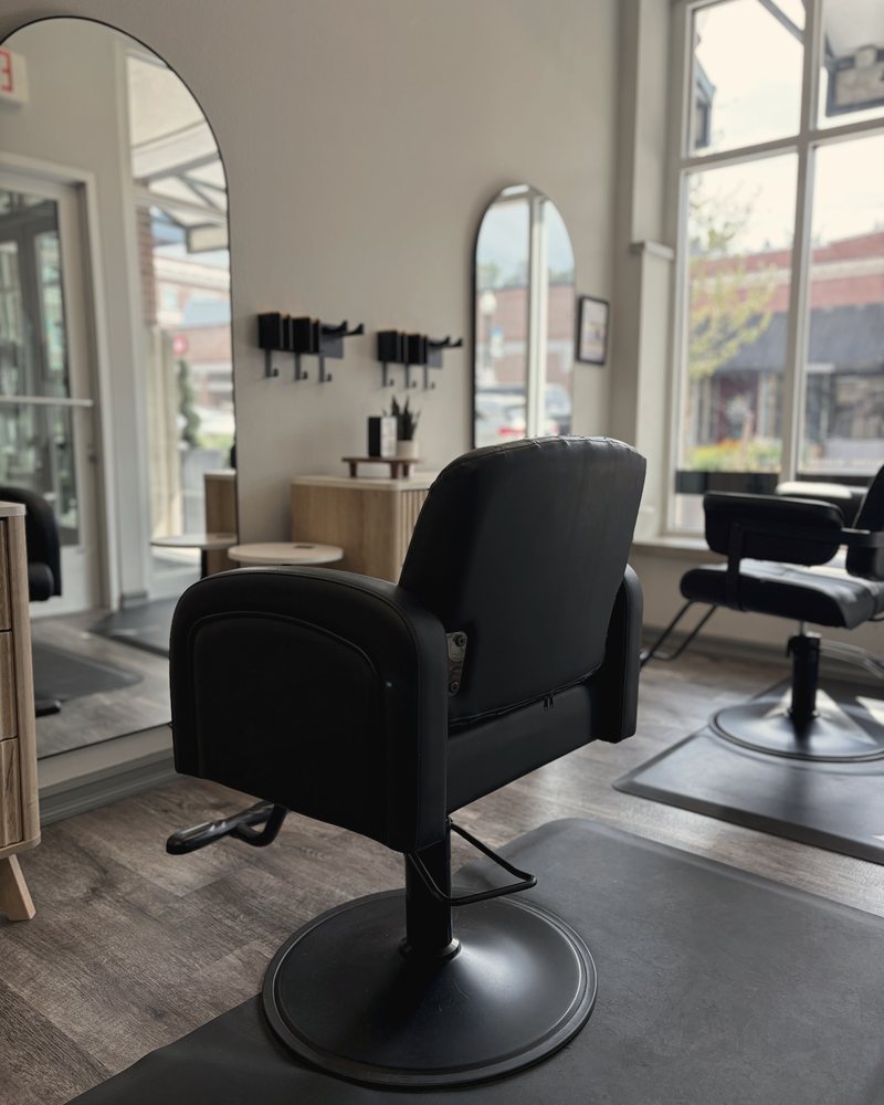 A styling station with the arched mirror and the window onto Main Street
