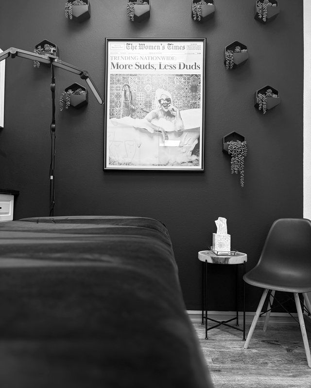 The spa treatment room at Identity, with the facial bed and lamp
